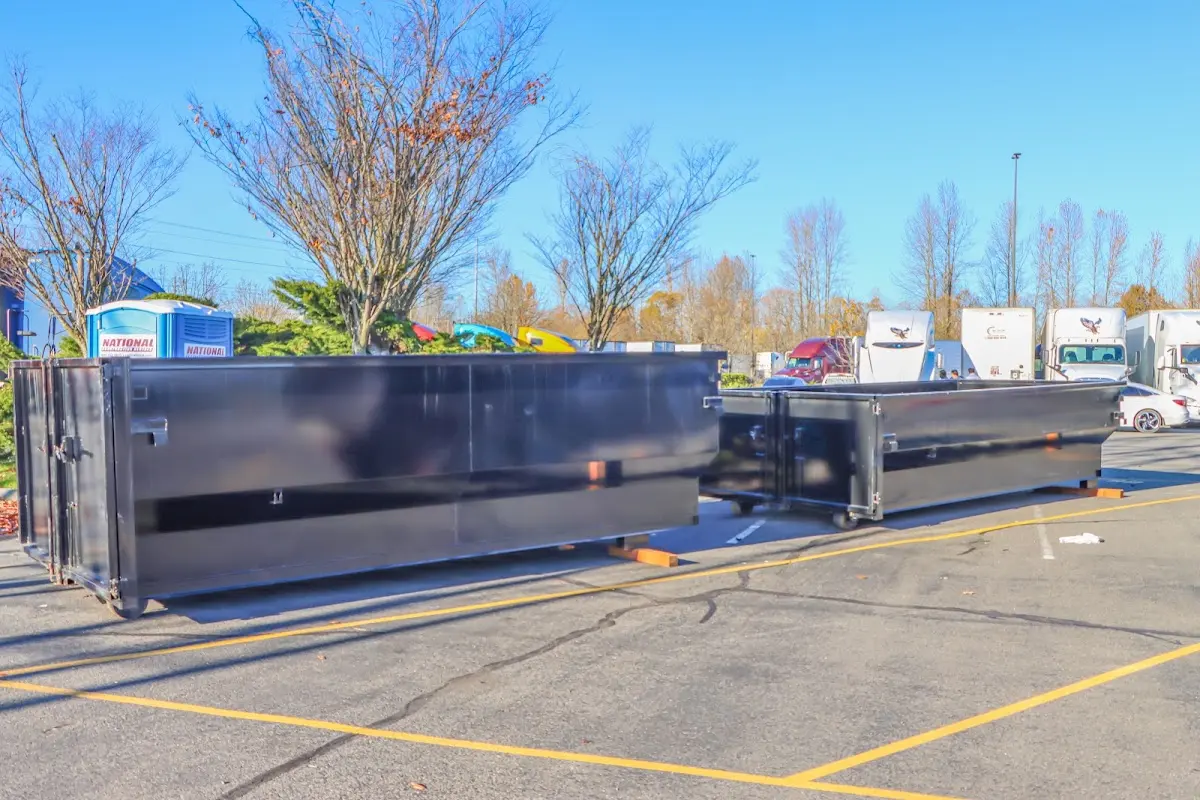 Professional dumpster rental service with roll-off container on residential driveway in Rawlins